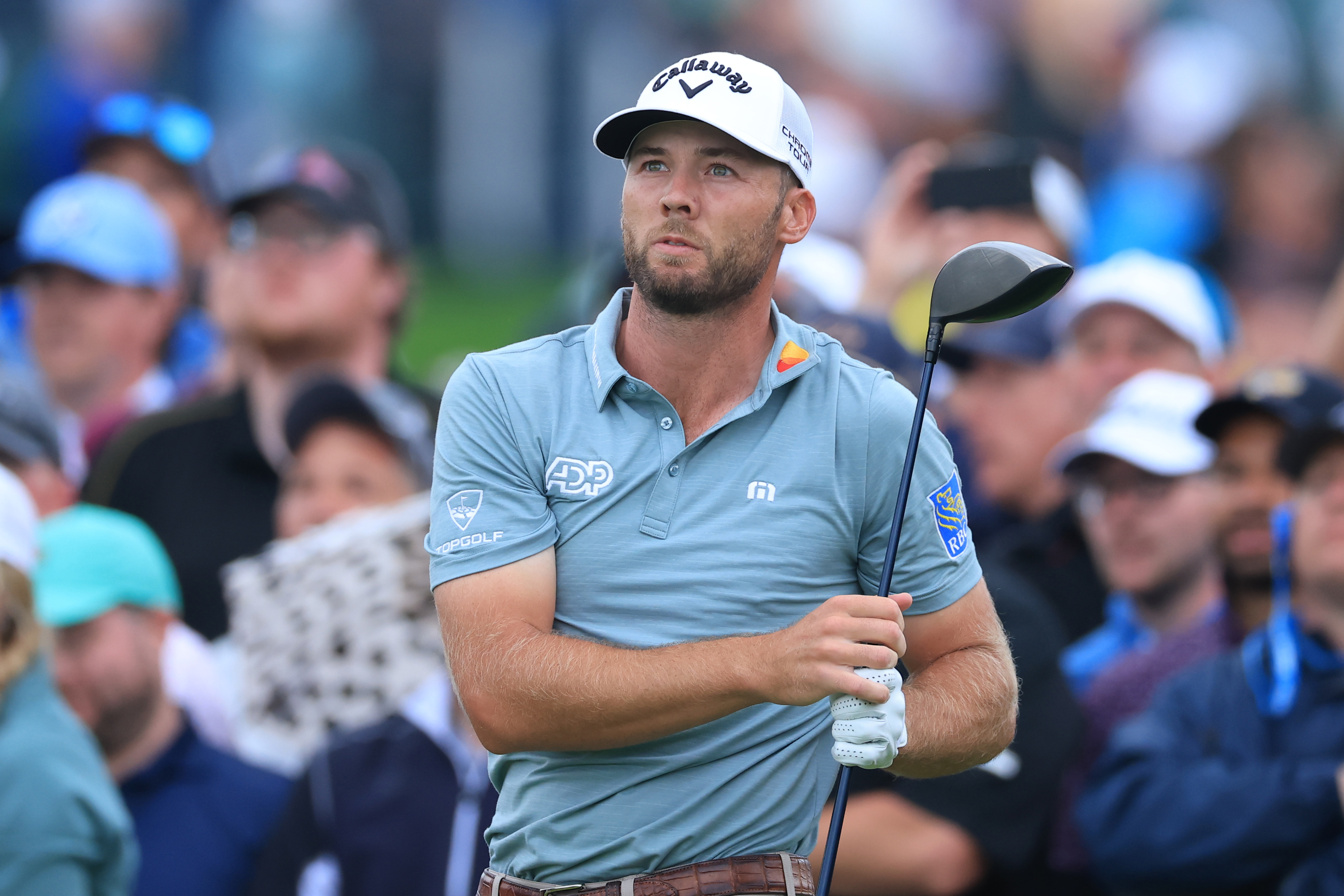 Sam Burns watches his tee shot with a driver