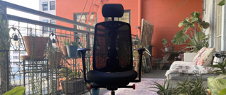 black vantum gaming chair on patio with plants