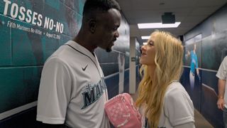 Kwame Appiah and Chelsea Griffin in baseball jerseys looking at each other in Love Is Blind: After the Altar season 4