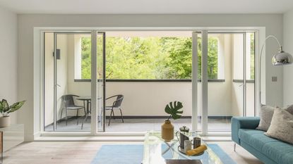 An apartment with open sliding balcony doors