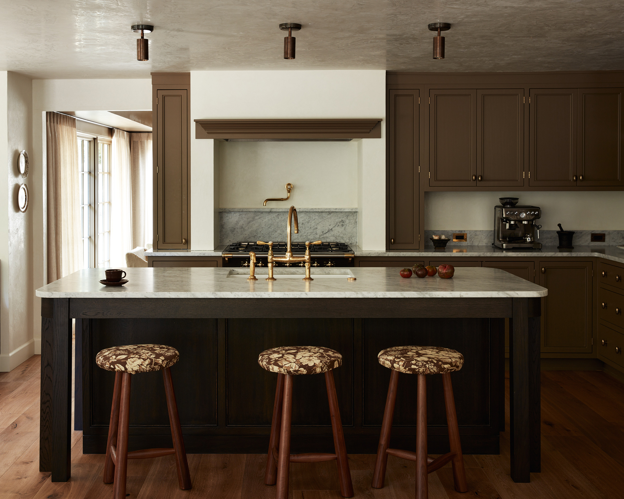 Kitchen with brown cabinets and wood stools