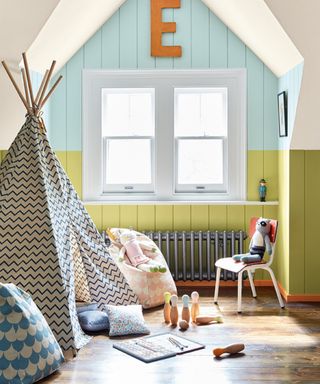 blue and green playroom with toys, tent, chair, shiplap walls, pouf