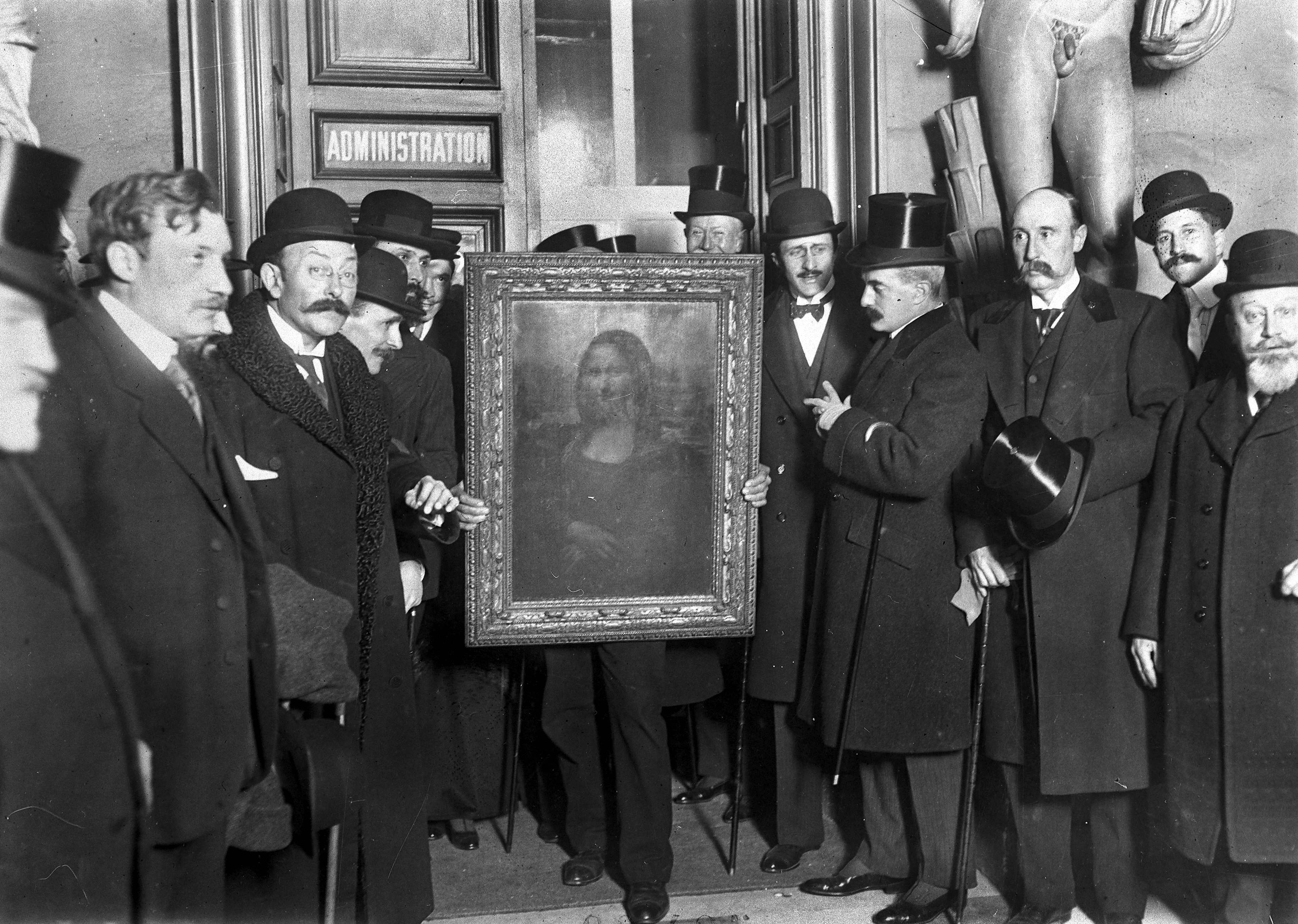  People gather around the Mona Lisa painting in 1914 in Paris after it was stolen from the Musee du Louvre