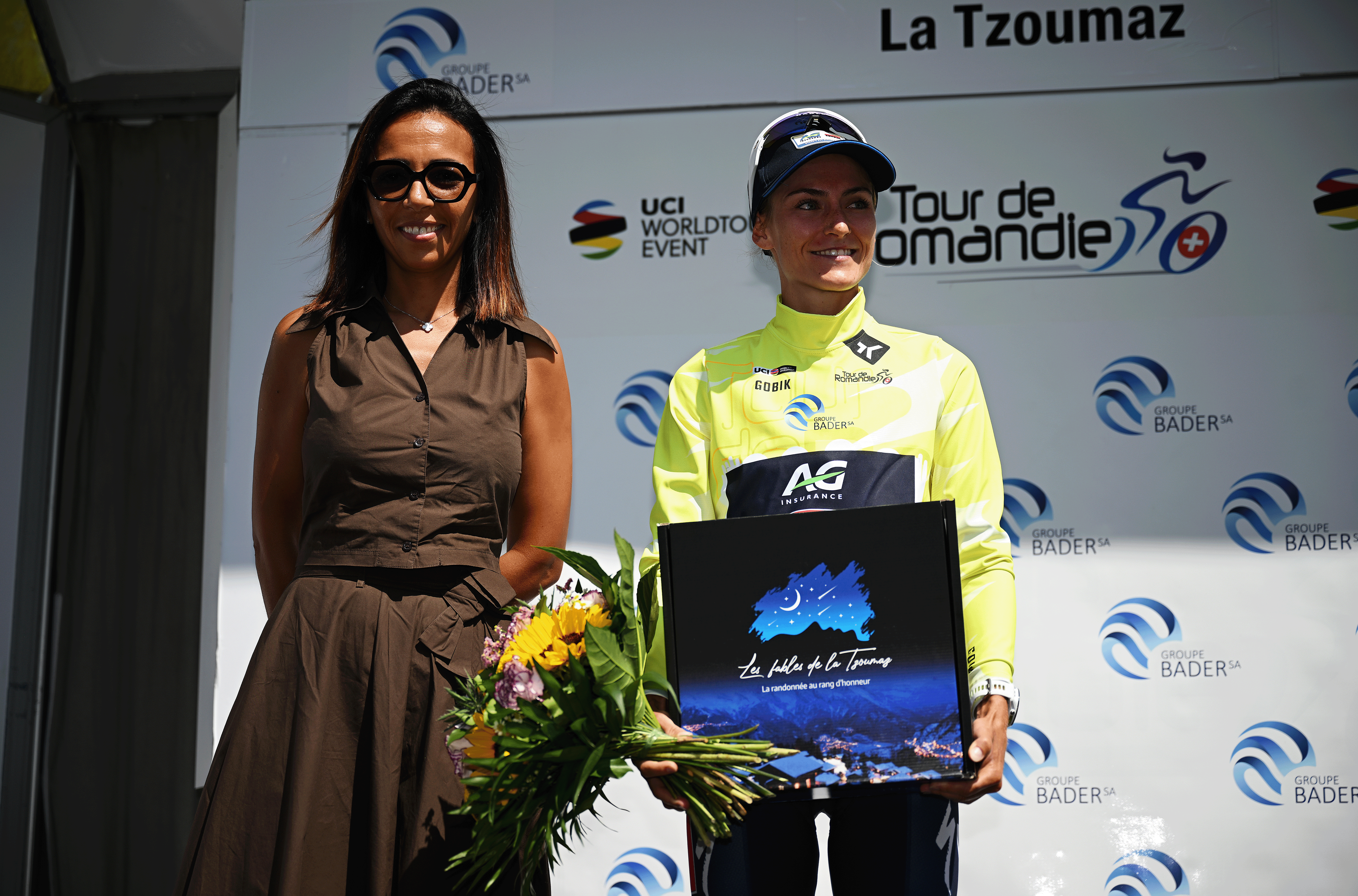 LA TZOUMAZ, SWITZERLAND - AUGUST 16: (L-R) Amina Lanaya, General Director, International Cycling Union (UCI) and Urska Zigart of Slovenia and Team AG Insurance - Soudal - Yellow Leader Jersey at podium during the 4th Tour de Romandie Feminin 2025, Stage 2 a 123.2km stage from Conthey to La Tzoumaz 1522m / #UCIWWT / on August 16, 2025 in La Tzoumaz, Switzerland. (Photo by Dario Belingheri/Getty Images)