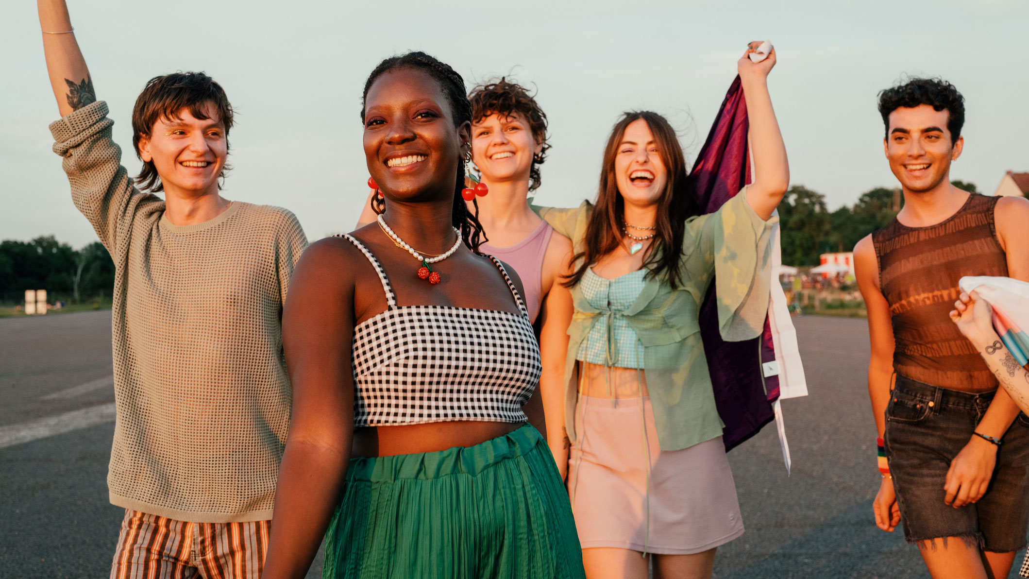 group of gen z people walking down street