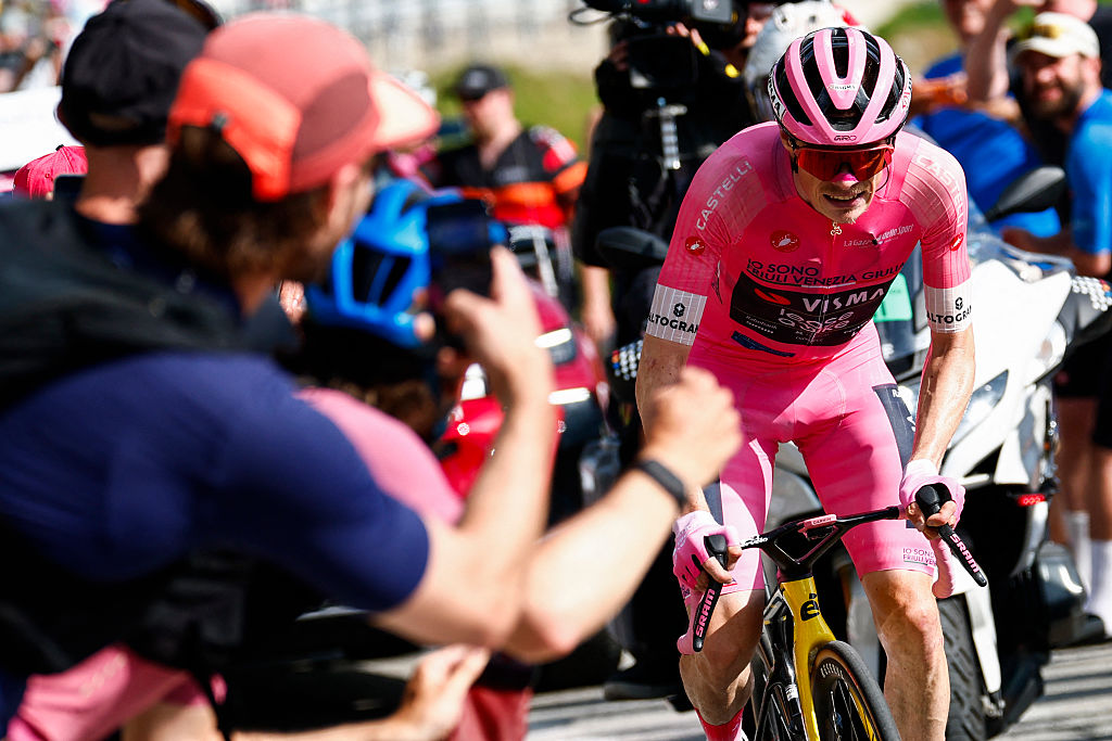 Team Visma Lease a Bike Danish rider Jonas Vingegaard wearing the overall leader's pink jersey (Maglia Rosa) attacks in the final climb during the 16th stage of the Giro d'Italia 2026 - Tour of Italy cycling race between Bellinzona and Cari, Switzerland, on May 26, 2026. (Photo by Luca Bettini / AFP)