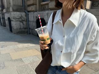 Marianne Smyth wears a white button-down and jeans