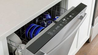 Top down view of the GE GDT550PYRFS Top Control Built In Dishwasher being opened after cycle