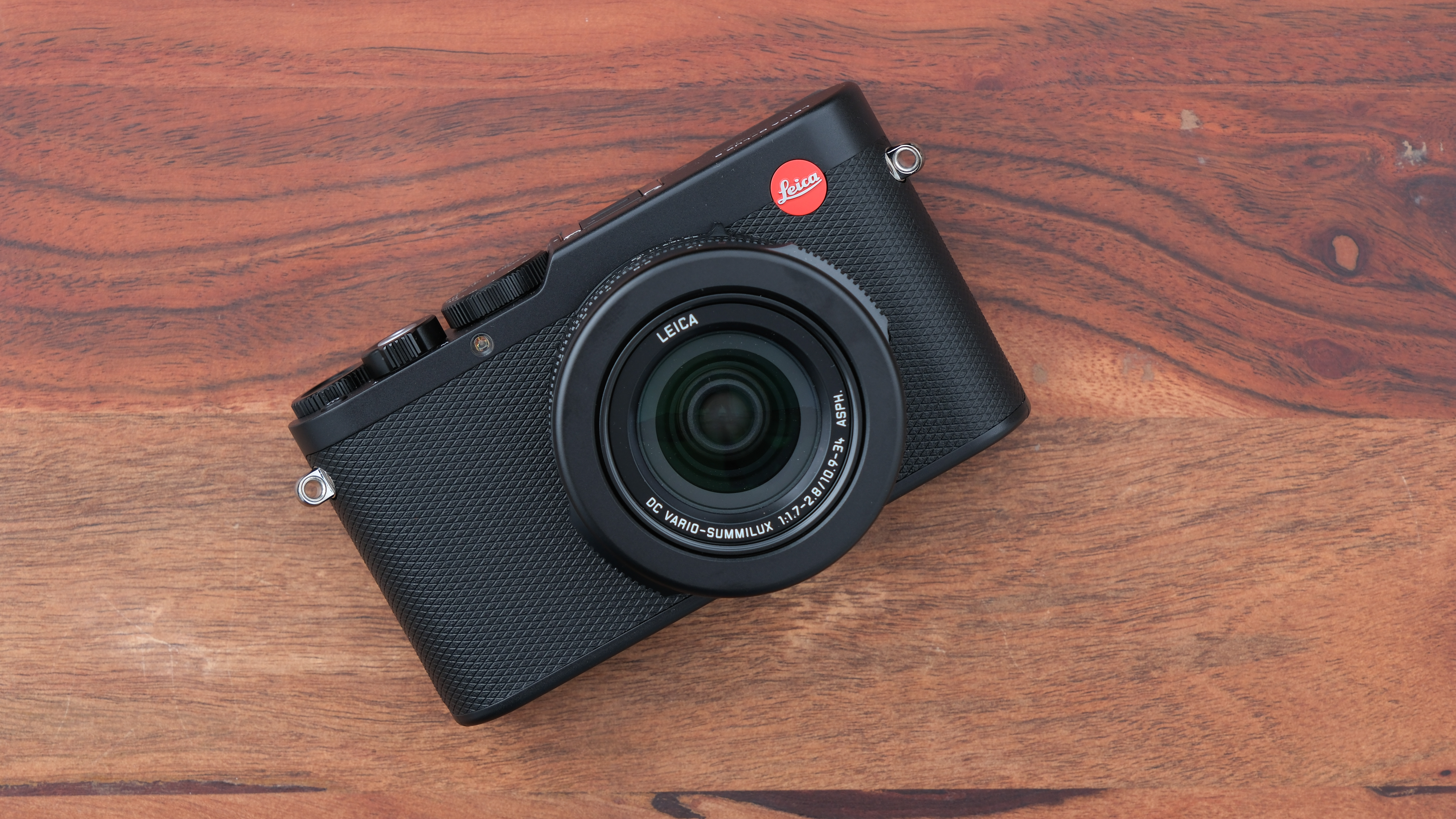 Leica D-Lux 8 camera on a wooden surface