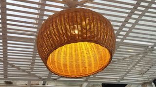 A basket lantern hanging from the ceiling