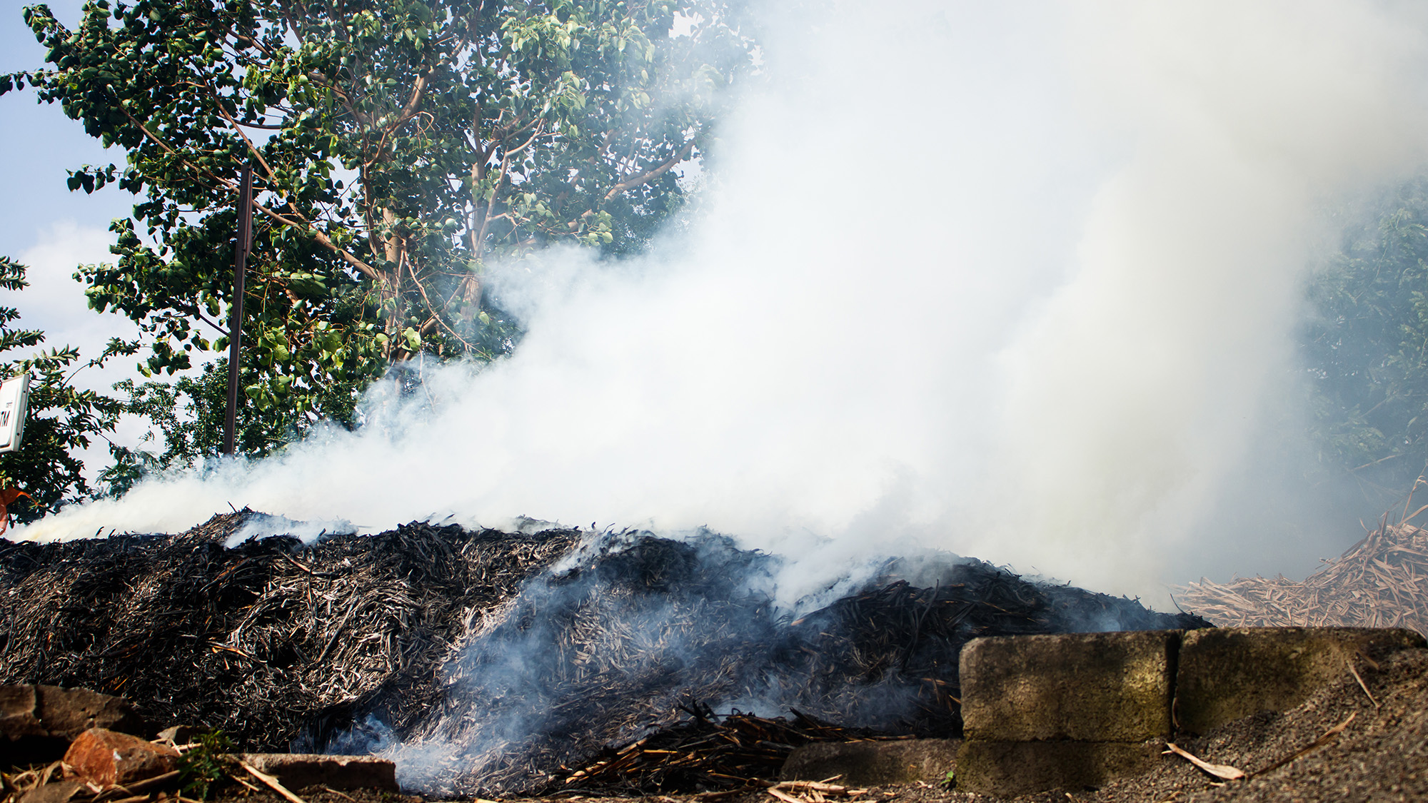 A ditch burns with white smoke filling the air.