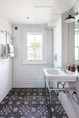 Small bathroom tile idea with white subways tiles and dark patterned floor tiles
