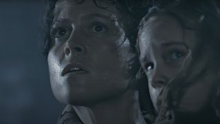 Sigourney Weaver and Carrie Henn look up together in fear in Aliens.