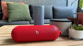 Beats Pill speaker in red and Sonos Roam 2 speaker in blue