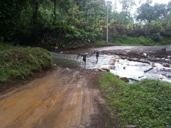 Pua Mata and Alex Grant cross one of many rivers while pre-riding stage 1