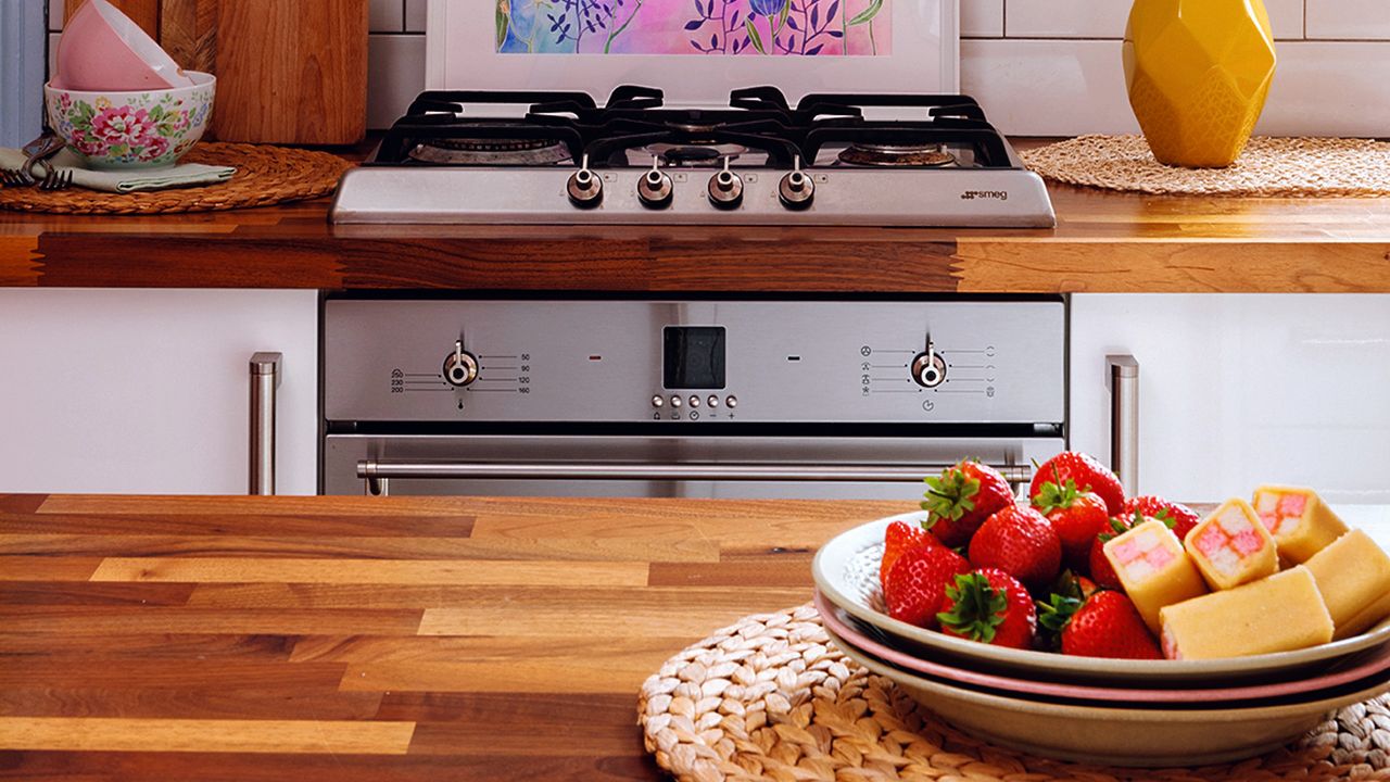 Strawberries and sweet snacks laid on bowl on top of kitchen countertop