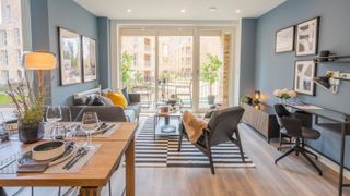 Modern living room setting with low grey sofas and blue walls