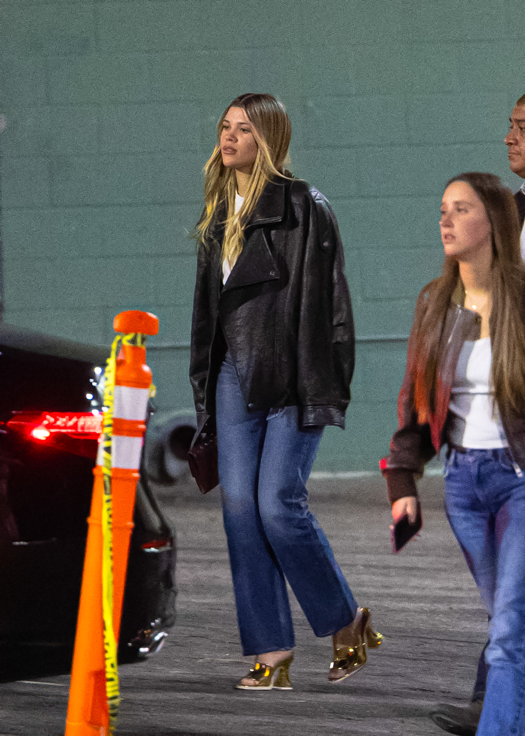 Sofia Richie wears a leather bomber jacket + jeans.