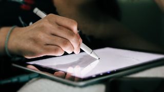 A close up of an Apple Pencil being used to show how to draw on the iPad