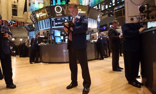 A stock trader works the floor of the New York Stock Exchange