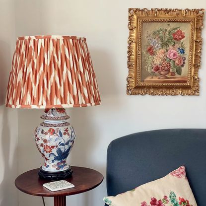 second hand lamp with a graphic shade next to a vintage painting