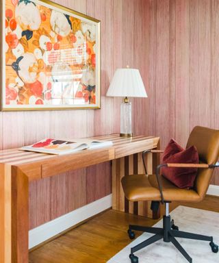 office with textured blush pink wallpaper and bright artwork