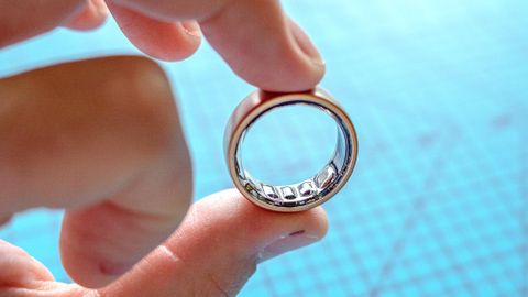 Amazfit Helio ring held between someone's fingers