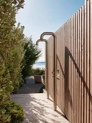 Sleek and contemporary outdoors showers area at the Surf House in California