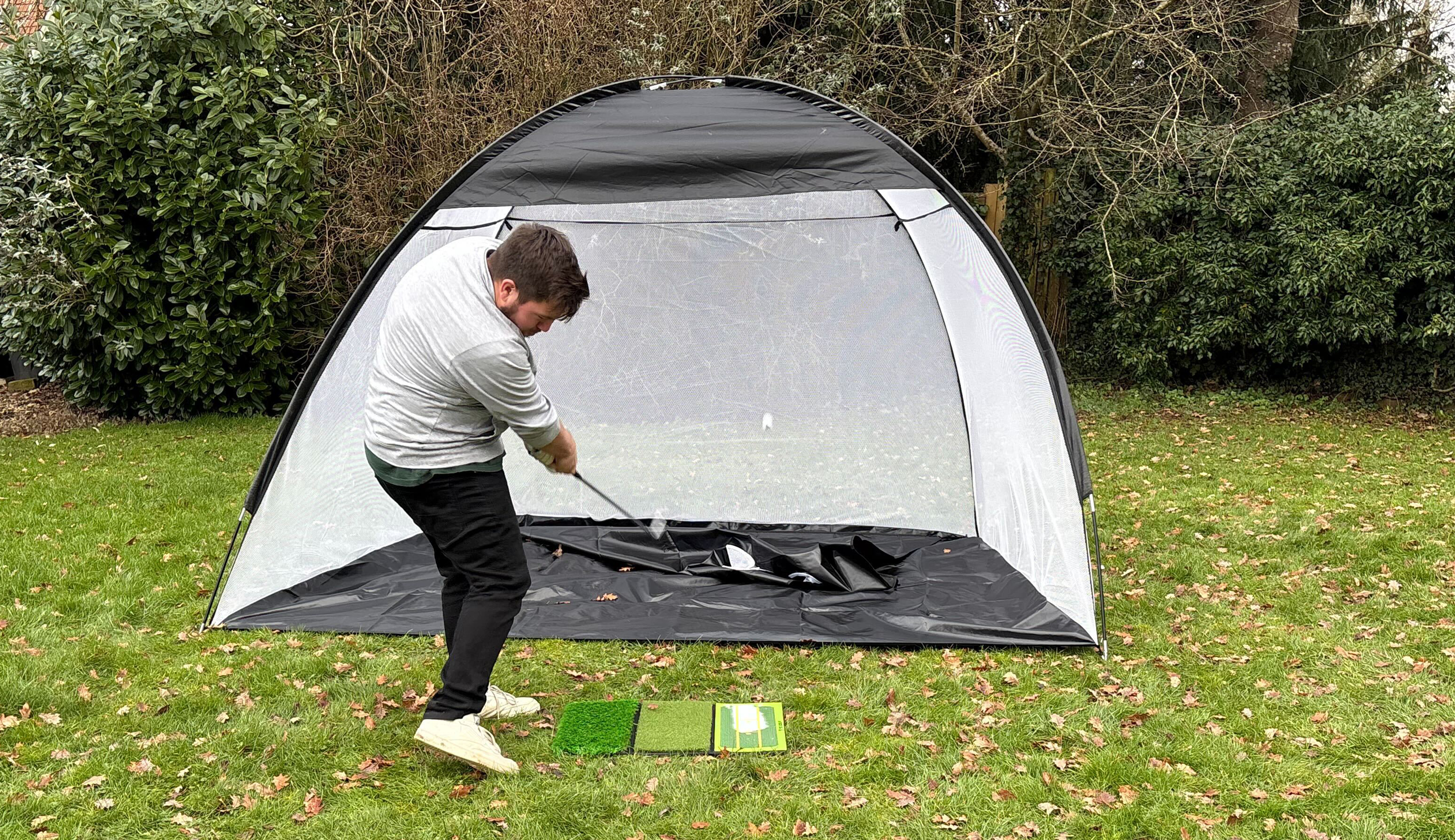 A golfer hits into the TS Golf Practice Net