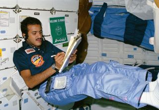 Saudi astronaut Sultan Salman Abdelize Al-Saud, a Saudi prince, logs notes while floating in the middeck of space shuttle discovery during the STS-51G mission to deploy the Arabsat-1B communications satellite in June 1985.