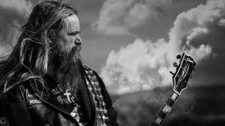 Zakk Wylde posing for a photograph with a guitar