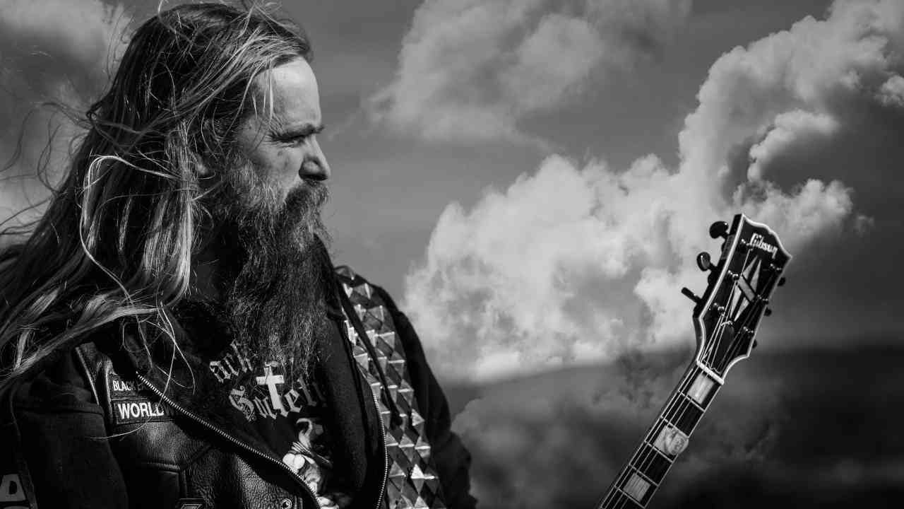 Zakk Wylde posing for a photograph with a guitar