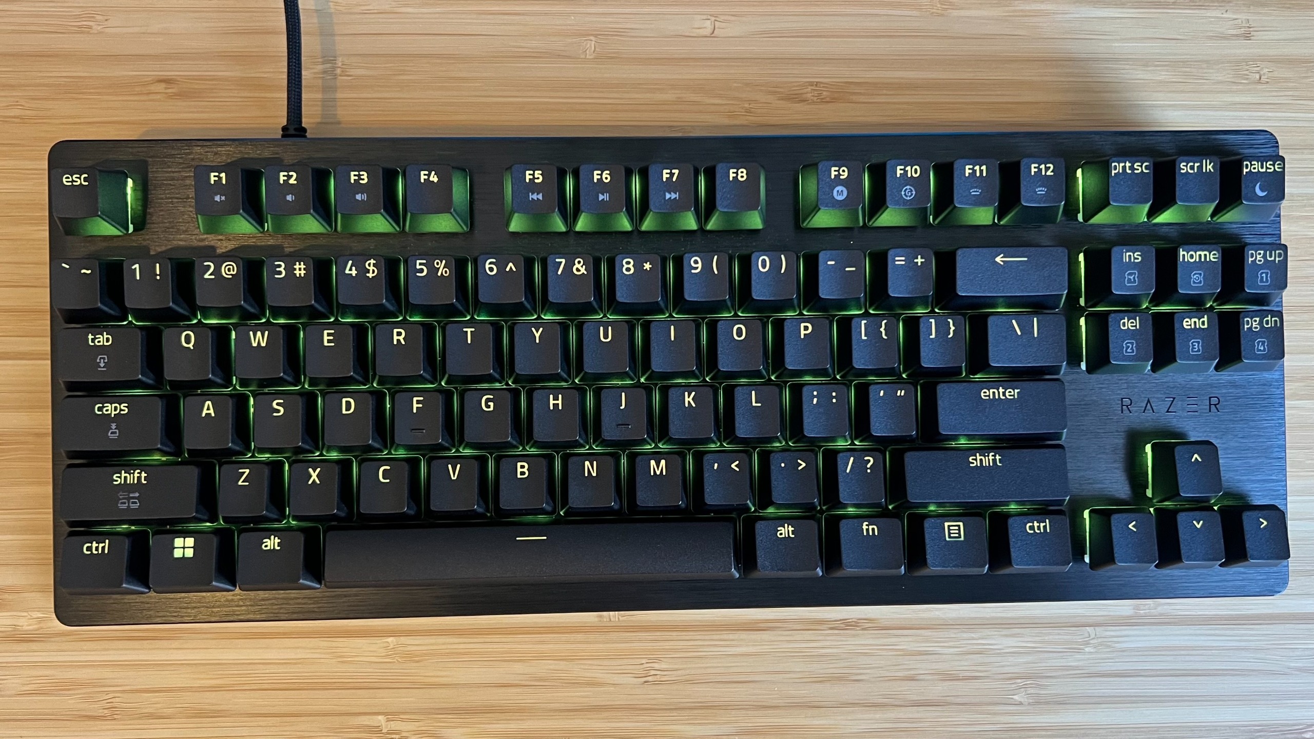 Razer Huntsman V3 HE gaming keyboard on a wooden desk