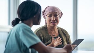 7 anxiety tips: A woman and her doctor sitting at a table as they go over information on a tablet.