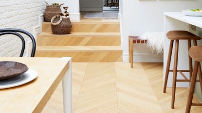 Wooden kitchen floor continued through to entrance hall used on a guide for how to clean hardwood floors