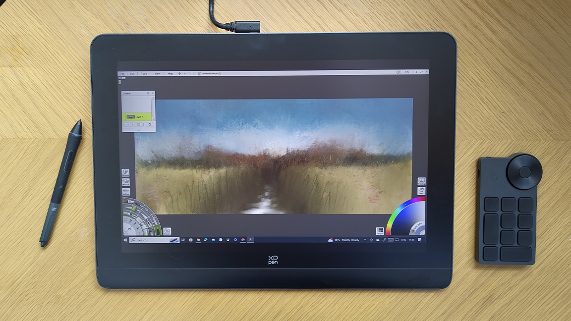 XP-Pen Artist Pro 16 (Gen 2) review; a graphics tablet on a wooden desk with accessories
