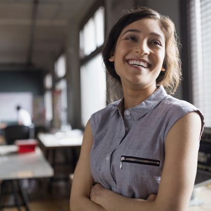 Woman smiling in an office.