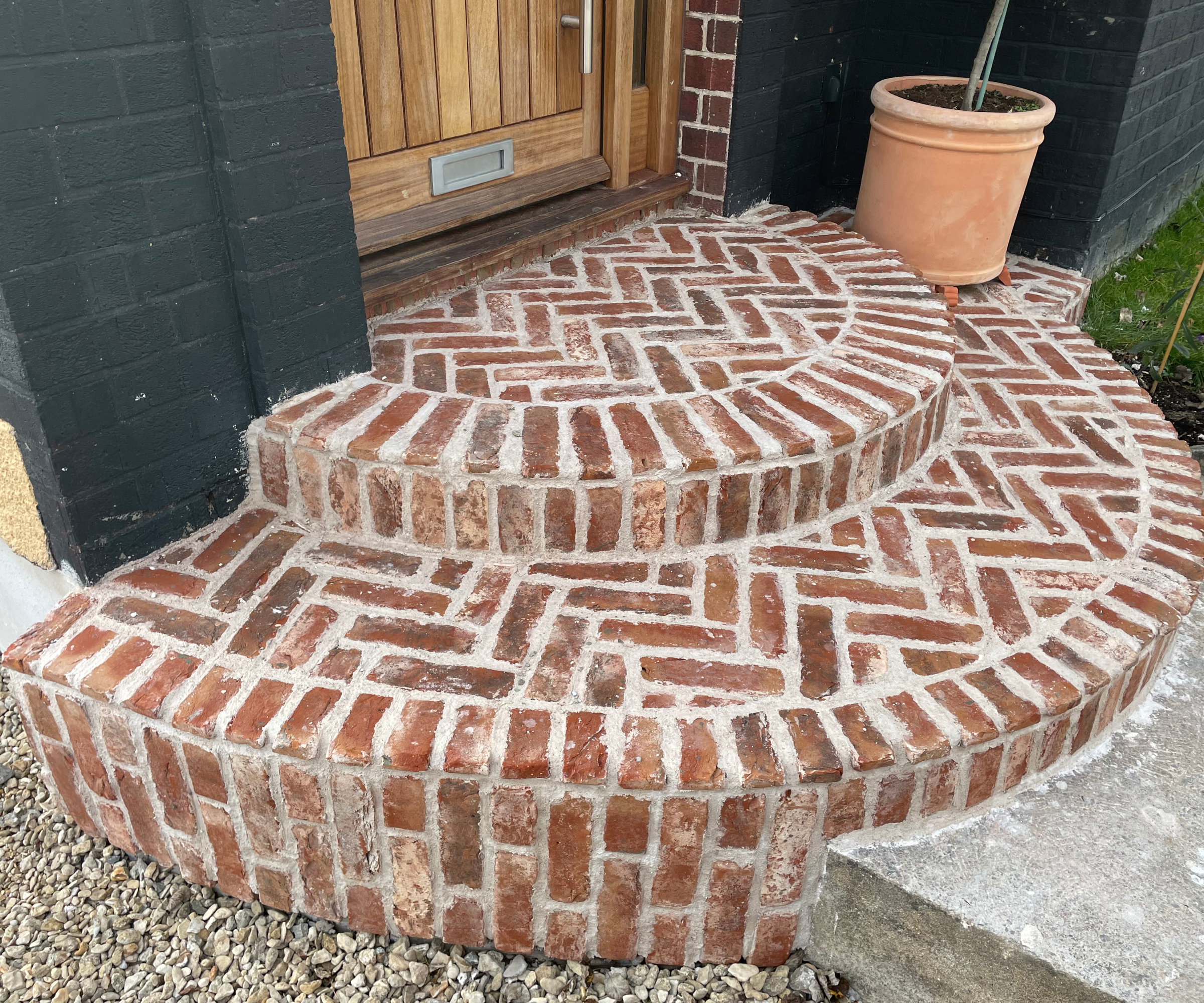 curved front door steps with brick faced cladding