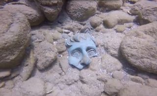 A fragment of a life-sized statue of a person found at the site of the Roman-era shipwreck.