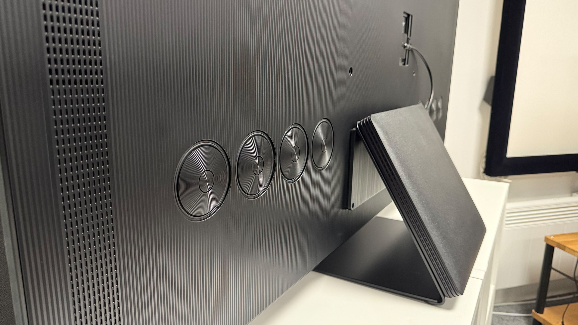 Samsung S95F OLED TV showing rear of TV and stand