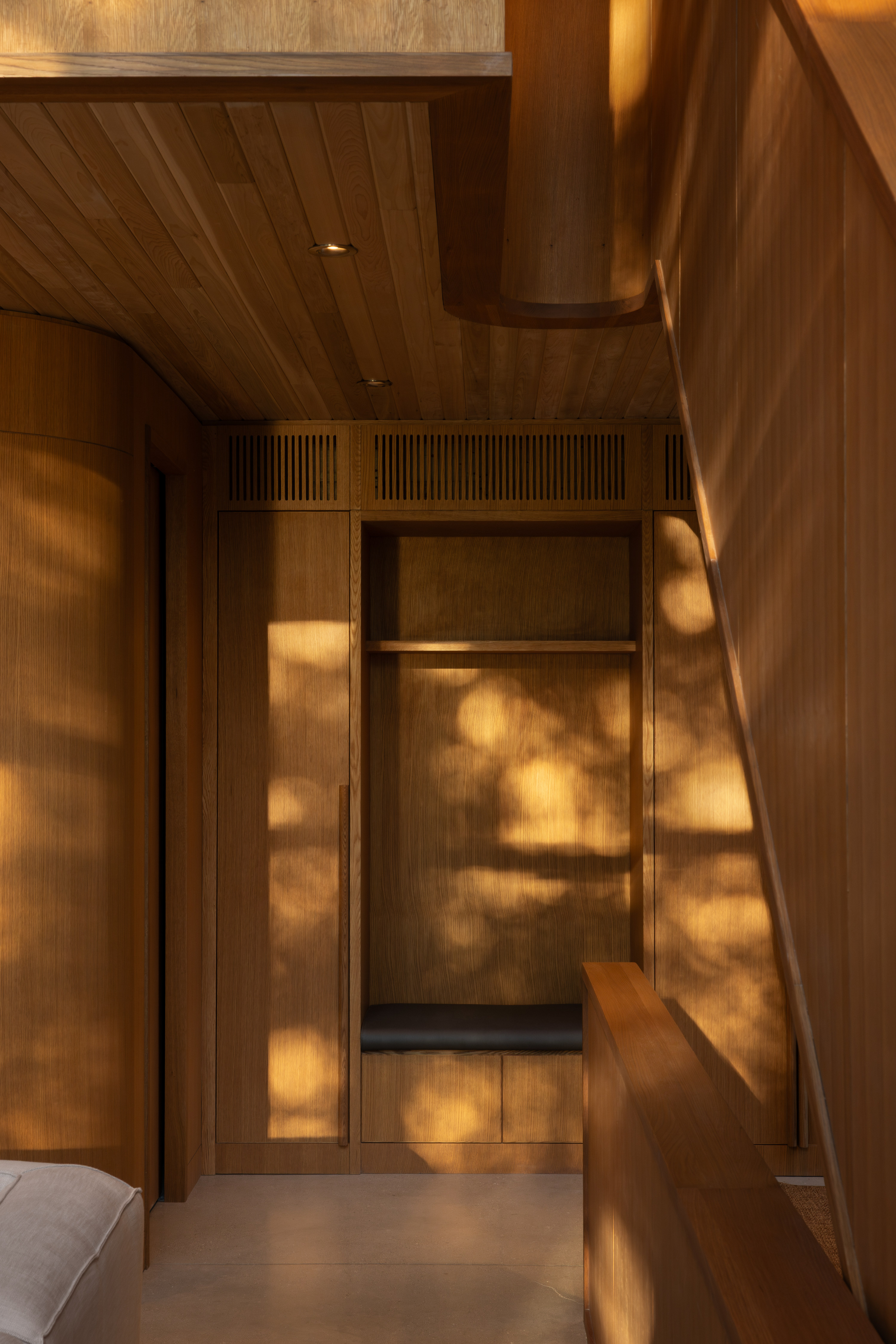The oak interior is dappled by evening light