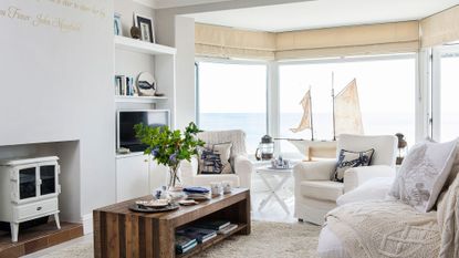 white theme living room with sofa set and tv unit