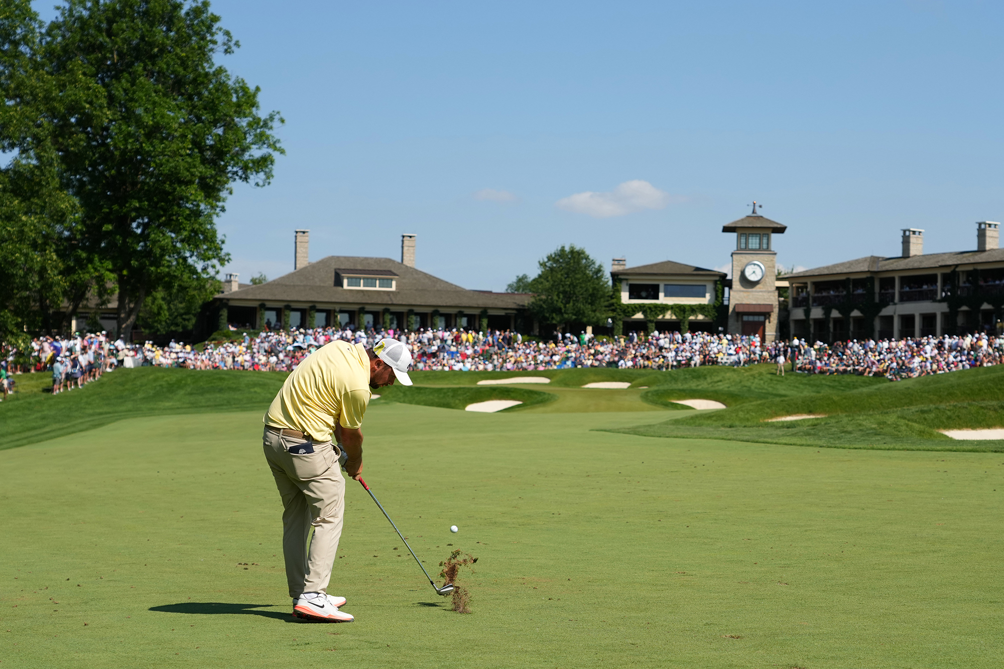 Alex Fitzpatrick hitting an iron shot on approach to the 18th green at Muirfield Village