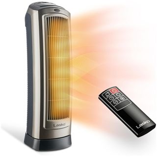 A black and silver space heater with black remote and orange heat rays