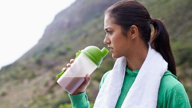 Woman drinking a shake made from the best protein powder for weight loss