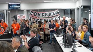 A room full of scientists celebrate Ingenuity's final signal