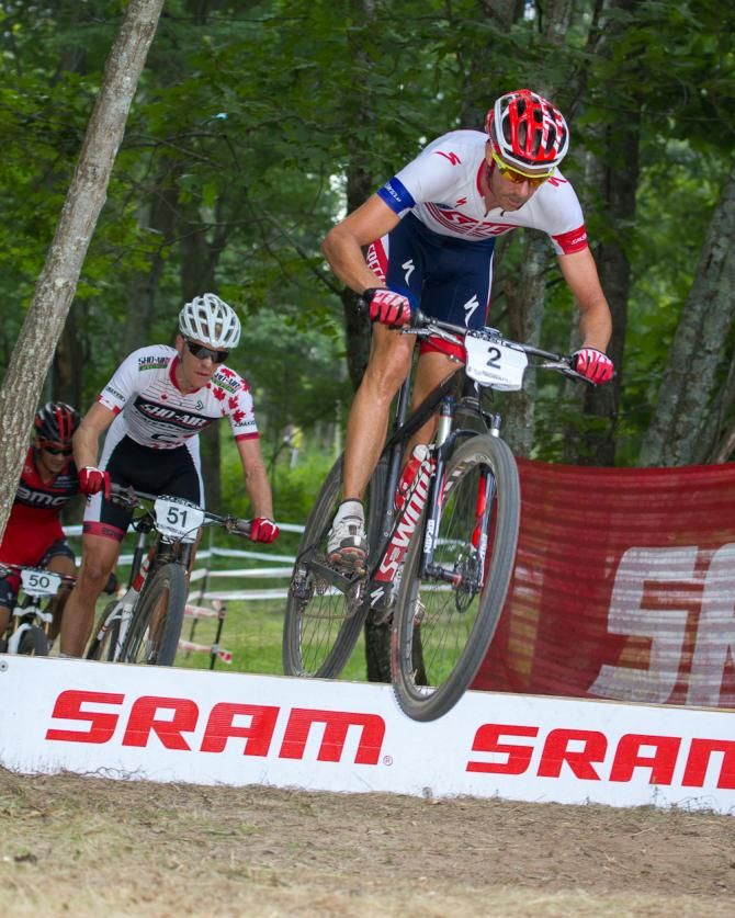 Todd Wells leading the pack over the ramp with Stephen Ettinger closing on Max Plaxton for the battle of 2nd place.
