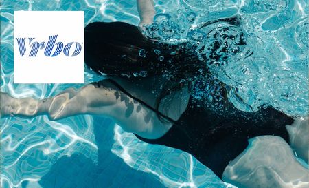 Woman in the pool at the house booked through Vrbo