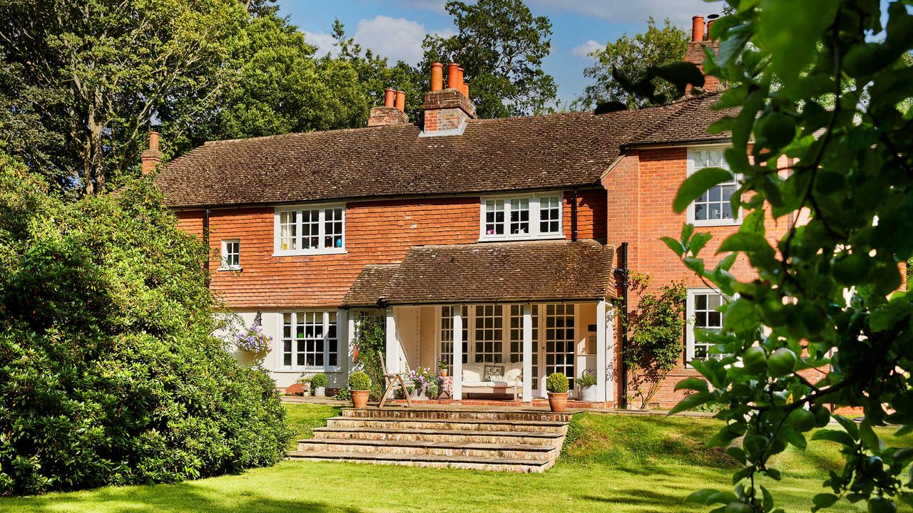 exterior of a country home with veranda and vertical hung tiles