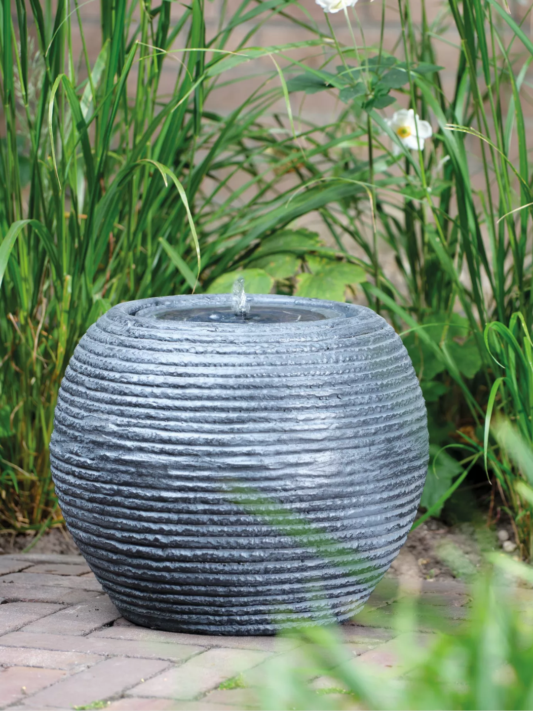 A textured round solar powered fountain from Kaemingk